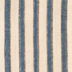 May include: A woven textile featuring a repeating pattern of vertical stripes. The design consists of wide off-white bands alternating with narrower blue stripes, each bordered by thin, dark black lines that run parallel across the fabric surface.