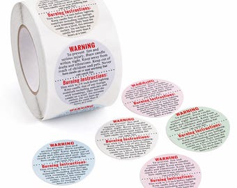 May include: A roll of white circular candle warning labels and several loose individual stickers in various pastel colors including blue, pink, green, and white. Each label features black text with the heading WARNING and Burning Instructions.