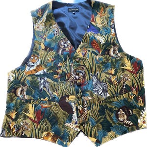 May include: A green, blue, and brown vest with a jungle print featuring various animals, including tigers, zebras, giraffes, monkeys, and toucans. The vest has a black lining and a label that reads "Santana".