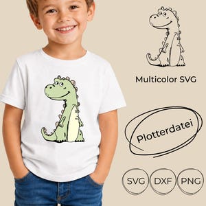 May include: A white t-shirt featuring a cartoon dinosaur graphic in shades of light green and cream. The design includes a black outline version labelled Multicolor SVG, the text Plotterdatei, and icons for SVG, DXF, and PNG file formats.