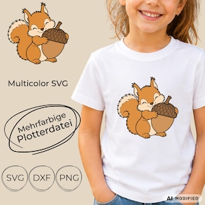 May include: A white t-shirt featuring a graphic of a brown squirrel holding a large brown acorn. The image also displays the text 'Multicolor SVG', 'Mehrfarbige Plotterdatei', and the file format labels 'SVG', 'DXF', and 'PNG' in black text.