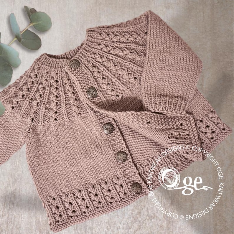 May include: A light pink knitted baby cardigan with a button closure and a delicate lace pattern. The cardigan has a round neckline and long sleeves.