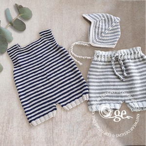 May include: A knitted baby set consisting of a navy and white striped romper, a matching grey and white striped bonnet with braided ties, and grey and white striped shorts with a drawstring waist, all featuring a ribbed texture.
