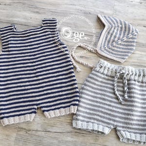 以下が含まれることがあります： 青と白のストライプのニット製ベビー服セット。セットには、ノースリーブロンパー、ショートパンツ、帽子が含まれています。