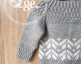 May include: A light gray knitted sweater featuring a white geometric chevron pattern across the lower body and sleeves. The garment has a ribbed neckline, cuffs, and hem, with a textured stitch detail at the wrists. The text Oge Knitwear Designs is visible.