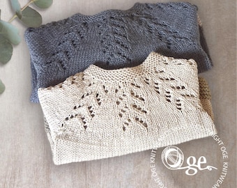 May include: Two knitted sweaters, one in a light beige colour and one in a dark grey colour, with a delicate lace pattern. The sweaters are folded and stacked on top of each other.