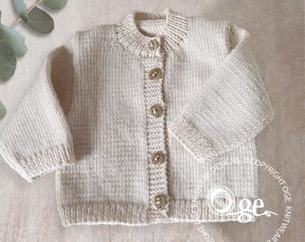 May include: A cream-colored knitted cardigan with a button closure. The cardigan has a round neckline and long sleeves. The buttons are decorated with a small floral design.