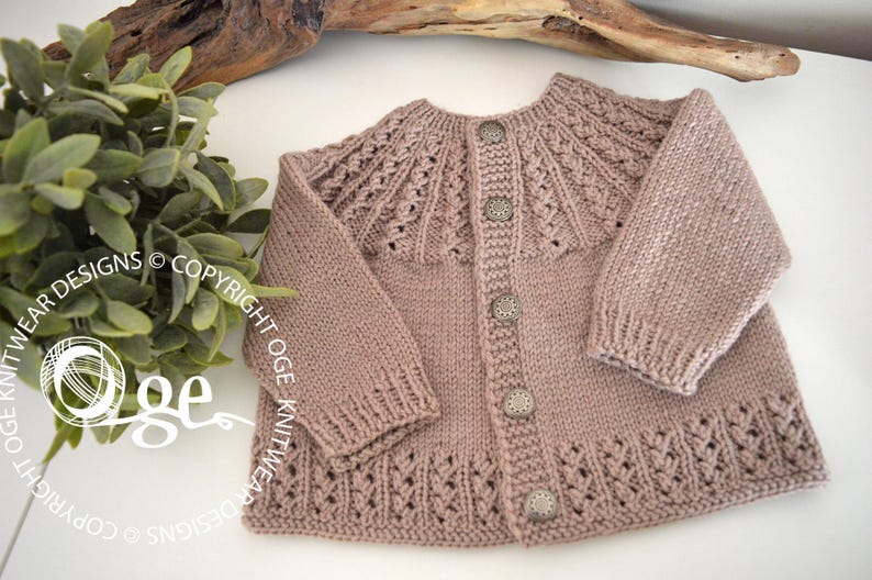 May include: A light brown knitted cardigan with a button closure and a delicate lace pattern around the neckline and hem.