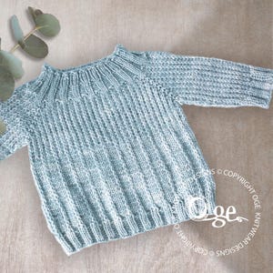 May include: A light blue knitted jumper with a ribbed texture. The jumper has a round neckline and long sleeves.