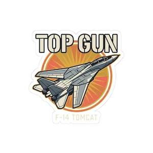 May include: A die-cut sticker featuring a gray F-14 Tomcat fighter jet flying in front of an orange and yellow sunburst circle. The text TOP GUN is printed in large beige letters above the jet, and F-14 TOMCAT is printed in smaller beige letters below.