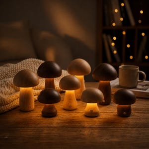 May include: A collection of eight mushroom-shaped lamps made of light and dark wood. Each lamp features a smooth, rounded cap and a cylindrical stem, emitting a warm, soft glow from underneath the cap. The lamps vary in size and wood tone.