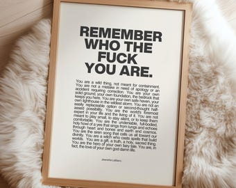 May include: A framed wall art print featuring the bold black text REMEMBER WHO THE FUCK YOU ARE followed by a long paragraph of inspirational text and the name Jeanette LeBlanc in a light wood frame with a clean white background.