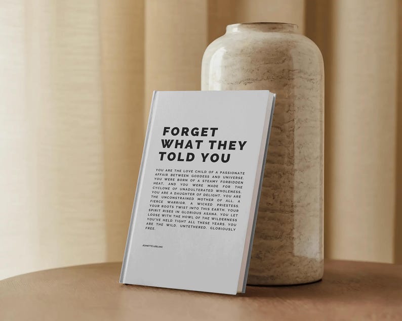 May include: A hardcover book with the title "FORGET WHAT THEY TOLD YOU" in bold black text. The book is propped up against a beige, textured vase. The book's pages contain additional text in a smaller font.