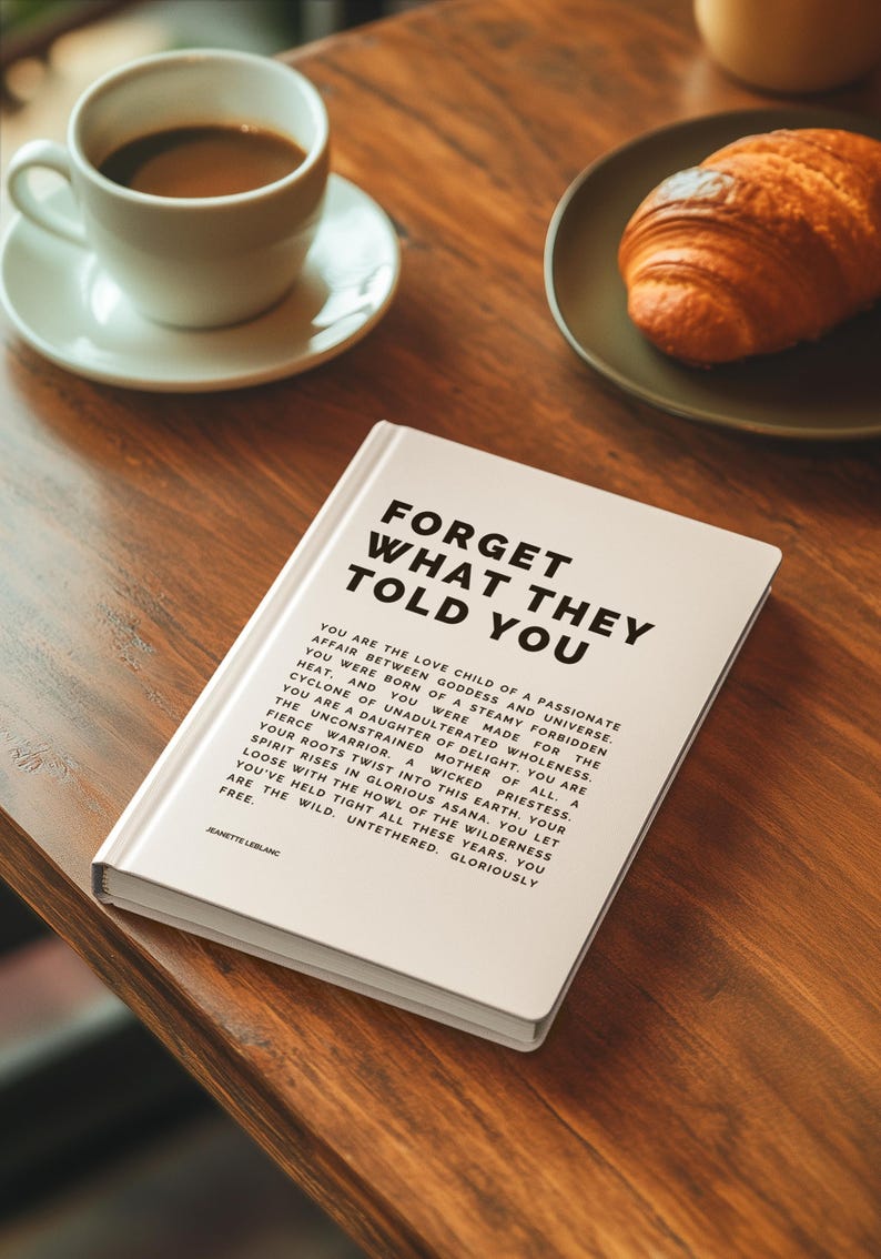 May include: A hardcover book titled "FORGET WHAT THEY TOLD YOU" with text on the cover and inside. A cup of coffee and a croissant are on a wooden table. The book is white with black text.