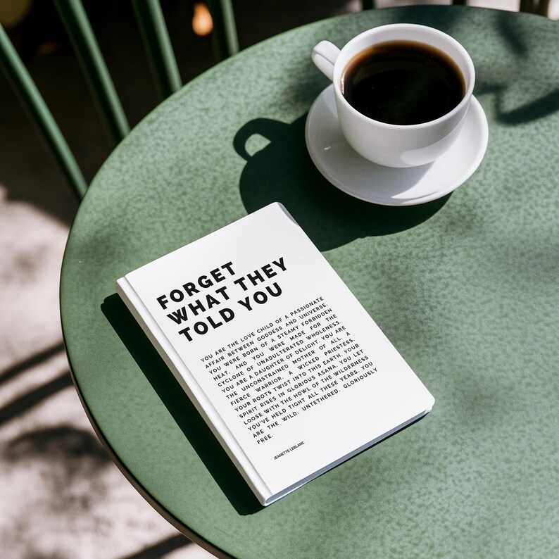 May include: A white book with the text "FORGET WHAT THEY TOLD YOU" and other text, next to a white coffee cup on a green table. The coffee cup is filled with black coffee.