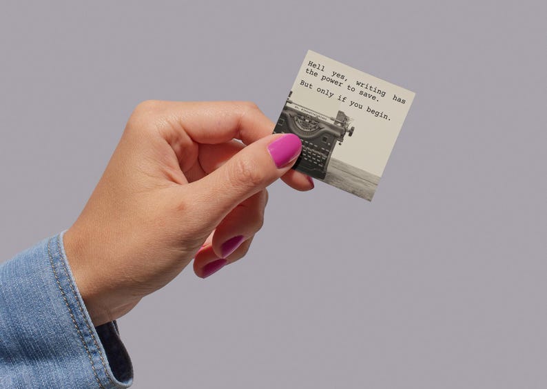 A sticker featuring a vintage typewriter and the words “Hell yes, writing has the power to save. But only if you begin.” Held in a hand, this Jeanette LeBlanc quote is perfect for writing encouragement and inspiration for creatives.
