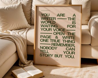 May include: A framed poster with a beige background and green text. The text reads "YOU ARE A WRITER - THE WORLD IS WAITING FOR YOUR VOICE - OPEN THE PAGE & WRITE ONE TRUE THING - REMEMBER, NOBODY CAN TELL YOUR STORY BUT YOU."
