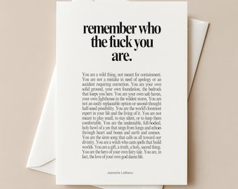 May include: A white greeting card featuring black text that reads, remember who the fuck you are, followed by a paragraph of inspirational text and the name Jeanette LeBlanc at the bottom. The card is placed on top of a matching white envelope.