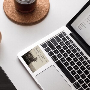 MacBook with a vintage typewriter sticker reading “Hell yes, writing has the power to save. But only if you begin.” A Jeanette LeBlanc quote inspiring writing motivation, creativity, and storytelling encouragement.