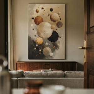 May include: A vertical wall art print featuring a celestial composition of various sized spheres in shades of cream, beige, brown, black, and gold. The spheres are arranged against a textured, abstract background with thin circular line accents.