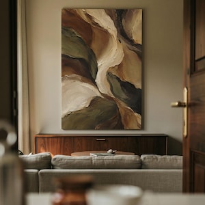 May include: A large rectangular canvas painting featuring thick, textured impasto brushstrokes in a palette of deep forest green, warm earth tones, shades of brown, and creamy off-white, creating an abstract, flowing, layered composition.