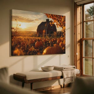 May include: A rectangular wall art print depicting a sunset over a pumpkin patch with a red barn in the background. The scene features orange pumpkins in the foreground, golden sunlight, and autumn foliage on a tree branch extending from the side.