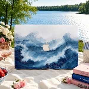 May include: A laptop cover featuring a detailed blue and white ocean wave design with a central cutout for an Apple logo. The artwork displays swirling water patterns in various shades of navy, cerulean, and white, creating a fluid, layered effect.