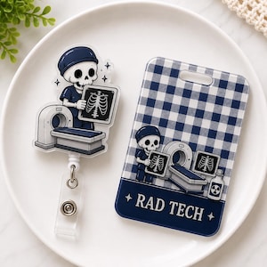 May include: An acrylic badge reel and a rectangular ID badge holder featuring a cartoon skeleton dressed as a radiology technician. The design includes a CT scanner, an X-ray image of a rib cage, and the text RAD TECH on a blue gingham background.