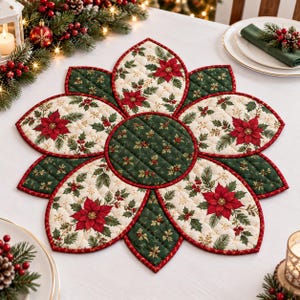 May include: A quilted fabric placemat shaped like a flower with alternating petals. The design features red poinsettias, green holly leaves, and berries on cream and dark green backgrounds, all finished with a thin red stitched border trim.
