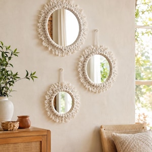 May include: Three circular wall mirrors featuring off-white macrame frames with intricate knotted patterns and fringed edges. Each mirror is suspended by a matching macrame cord loop, creating a cohesive set of decorative wall-mounted accents.
