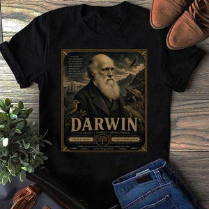 Op de afbeelding: Een zwart T-shirt met korte mouwen en een grafische print van Charles Darwin. Het ontwerp bevat een portret van Darwin, een schildpad, een vogel, een schip en de tekst: Darwin, Naturalist, Thinker, Revolutionary, Origin of Species, By Means of Natural Selection.
