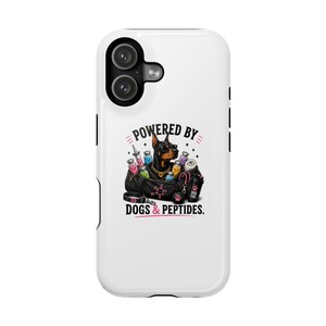 May include: A white phone case featuring a graphic of a Doberman wearing sunglasses and a gold chain, surrounded by colourful vials, a syringe, and a black gym bag. The text reads POWERED BY DOGS & PEPTIDES with a pink paw print and chemical structure.