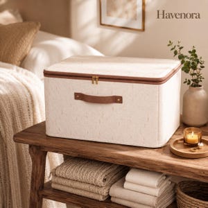 May include: A rectangular off-white storage bin with a textured fabric finish, featuring a brown zip closure and a brown handle secured with metal rivets. The brand name Havenora is printed in the upper right corner of the image.