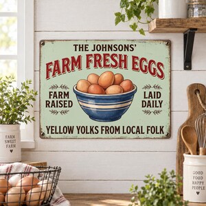 May include: A rectangular metal sign with a light green background featuring a blue bowl filled with brown eggs. The text reads: THE JOHNSONS' FARM FRESH EGGS, FARM RAISED, LAID DAILY, and YELLOW YOLKS FROM LOCAL FOLK. The sign has four corner holes.