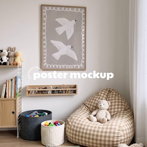 May include: A framed vertical poster featuring two white birds in flight against a gray background, enclosed by a white hand-drawn swirl border. The artwork is displayed in a light wood frame, positioned on a wall above a wooden shelf with toy animals.