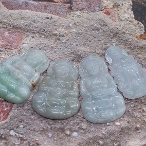May include: Four jade green figurines of sitting figures, each with intricate details and a smooth, polished finish.