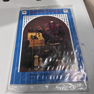 May include: A sewing pattern envelope titled Back Porch Press Wacky Patchwork Jacket. The cover features a dark patchwork cardigan, a vintage sewing machine, two dress forms, and scissors. The text includes sizes 6-20 and the year 1996.