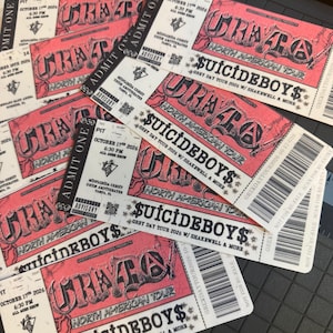 May include: A collection of rectangular concert tickets for the Grey Day Tour 2026 featuring $uicideboy$. The tickets are pink and white with black text, displaying the date October 17, 2026, the venue MidFlorida Credit Union Amphitheater, and a barcode.