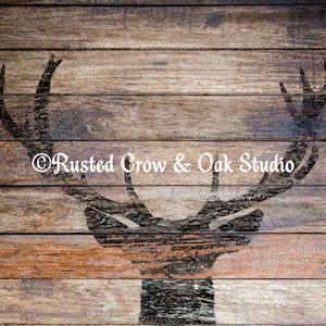 Pu&ograve; includere: Uno sfondo in legno rustico con una silhouette di una testa di cervo in stencil. Lo stencil &egrave; dipinto di nero ed &egrave; centrato sul legno. Il testo "Rusted Crow & Oak Studio" &egrave; stampato in bianco nella parte inferiore dell'immagine.