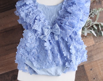 Periwinkle and a Kiss - sitter 12-18month romper in a soft dusty periwinkle lace with 3-D flowers
