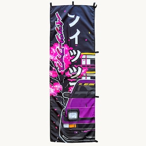 May include: A vertical black fabric banner featuring a purple sports car with pop-up headlights. The design includes bright pink cherry blossom branches and white Japanese katakana text. The banner has black fabric loops along the side edges.