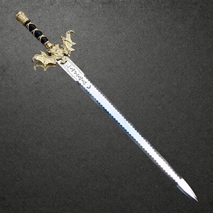 May include: A decorative sword featuring a silver-toned blade with a serrated edge and engraved text. The hilt has a black grip wrapped in gold wire, and a gold-colored crossguard shaped like a winged creature with intricate detailing.