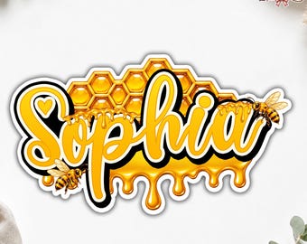 May include: A decorative patch featuring the name Sophia in bold yellow script with a black outline. The design includes a honeycomb background and dripping honey effects, accented by two small honeybees. The text QueenPatch appears in the corner.