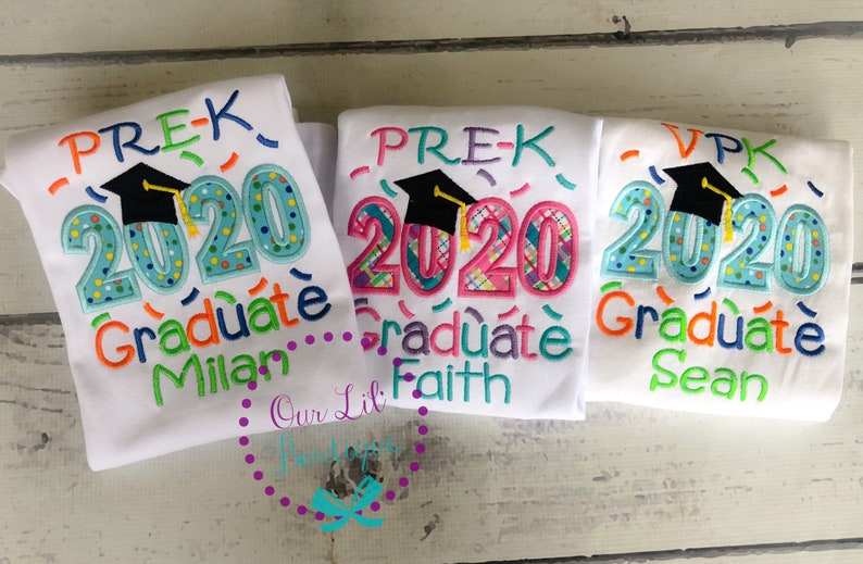 May include: Three white t-shirts with colorful embroidered designs celebrating graduation from preschool. The shirts say "Pre-K 2020 Graduate" with a graduation cap and confetti. The names Milan, Faith, and Sean are embroidered on each shirt.