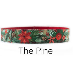 May include: Red and green Christmas-themed fabric with a pine tree, poinsettia, and berry pattern. The fabric is sewn into a loop, suggesting it is a dog collar. The text "The Pine" is printed below the fabric.