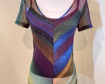 May include: A sheer, short-sleeved, v-neck top with an abstract print in shades of blue, green, brown, and purple.