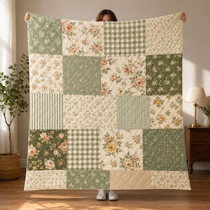 May include: A quilted throw blanket featuring a patchwork design of alternating squares. The pattern includes sage green and cream floral prints, a green and white gingham check, and thin vertical stripes in muted green and beige tones.