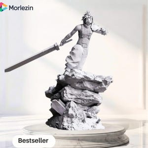 May include: A monochromatic 3D printed figurine of a spiky-haired character standing on a jagged rock formation. The figure wears a sleeveless top, loose pants, and a shoulder pauldron, while holding a large, flat sword extended to the side.