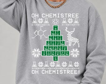 May include: A grey crewneck sweatshirt featuring a graphic of a Christmas tree constructed from green periodic table element squares. The design includes the text OH CHEMISTREE, chemical structures, snowflakes, and a reindeer silhouette.