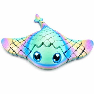 May include: A multi-coloured, articulated stingray figurine featuring a gradient of pastel blue, green, yellow, and pink hues. The creature has a segmented, scale-like texture across its back, large black eyes with white highlights, and a tail.